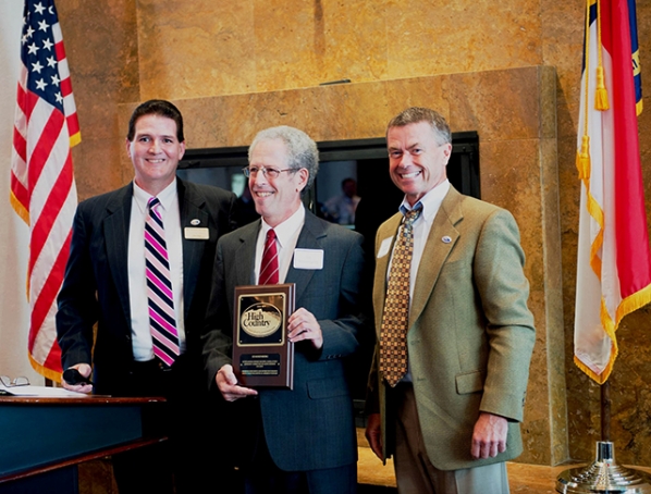 Mickey Duvall (left) and Gary D. Blevins (right) with Ed Rosenbeg (center) holding award