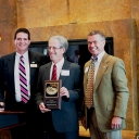 Mickey Duvall (left) and Gary D. Blevins (right) with Ed Rosenbeg (center) holding award